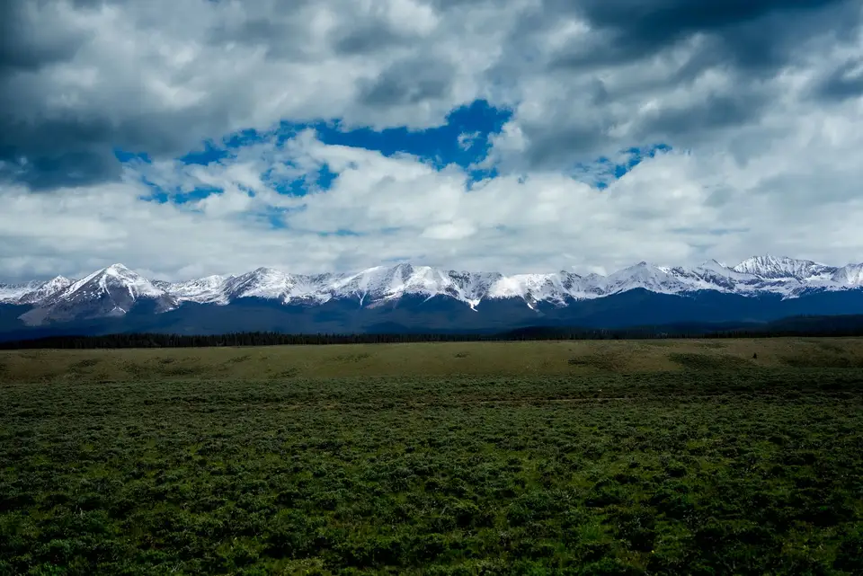 Storm clouds over the snow-capped Sawatch Range from the sagebrush flats