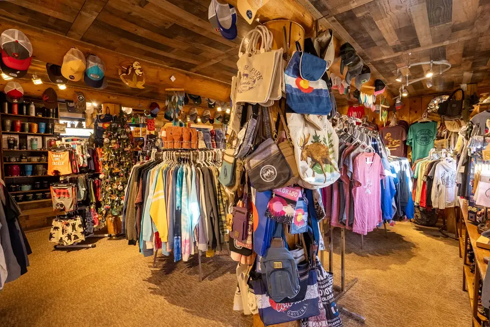 Gift shop racks of T-shirts, hats and bags