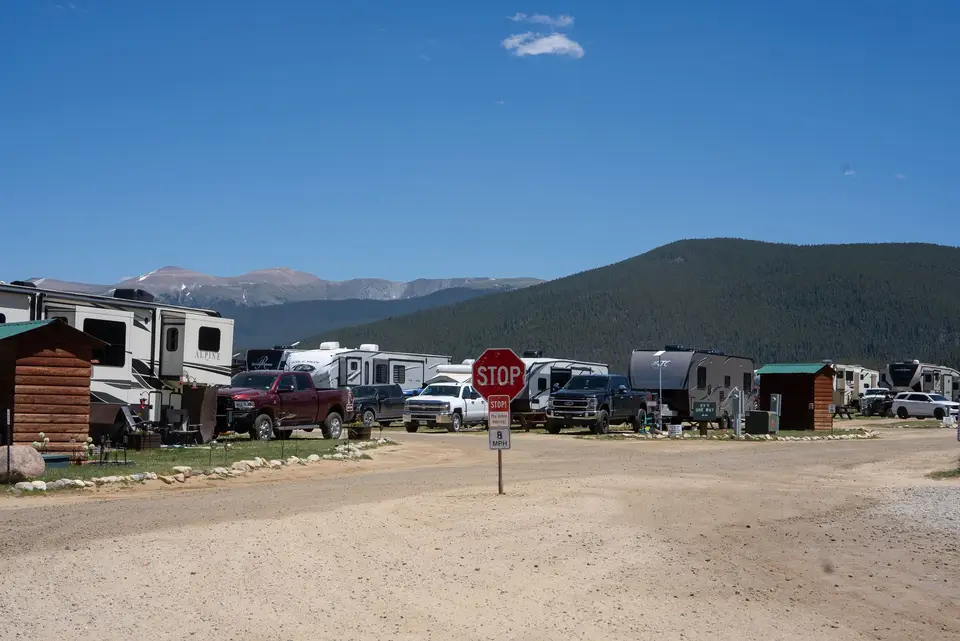 RVs parked in rows with the mountains behind