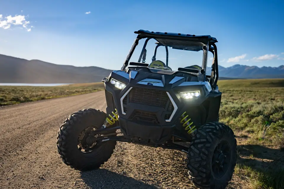 A rental RZR on a dirt road with the reservoir behind