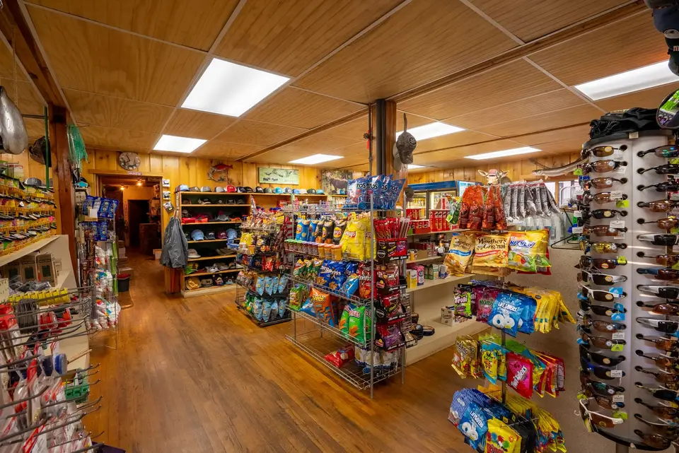 Store shelves stocked with snacks, drinks and camping supplies